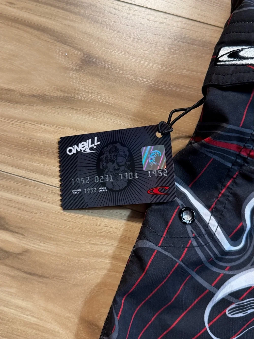 O'Neill black board shorts with white and red